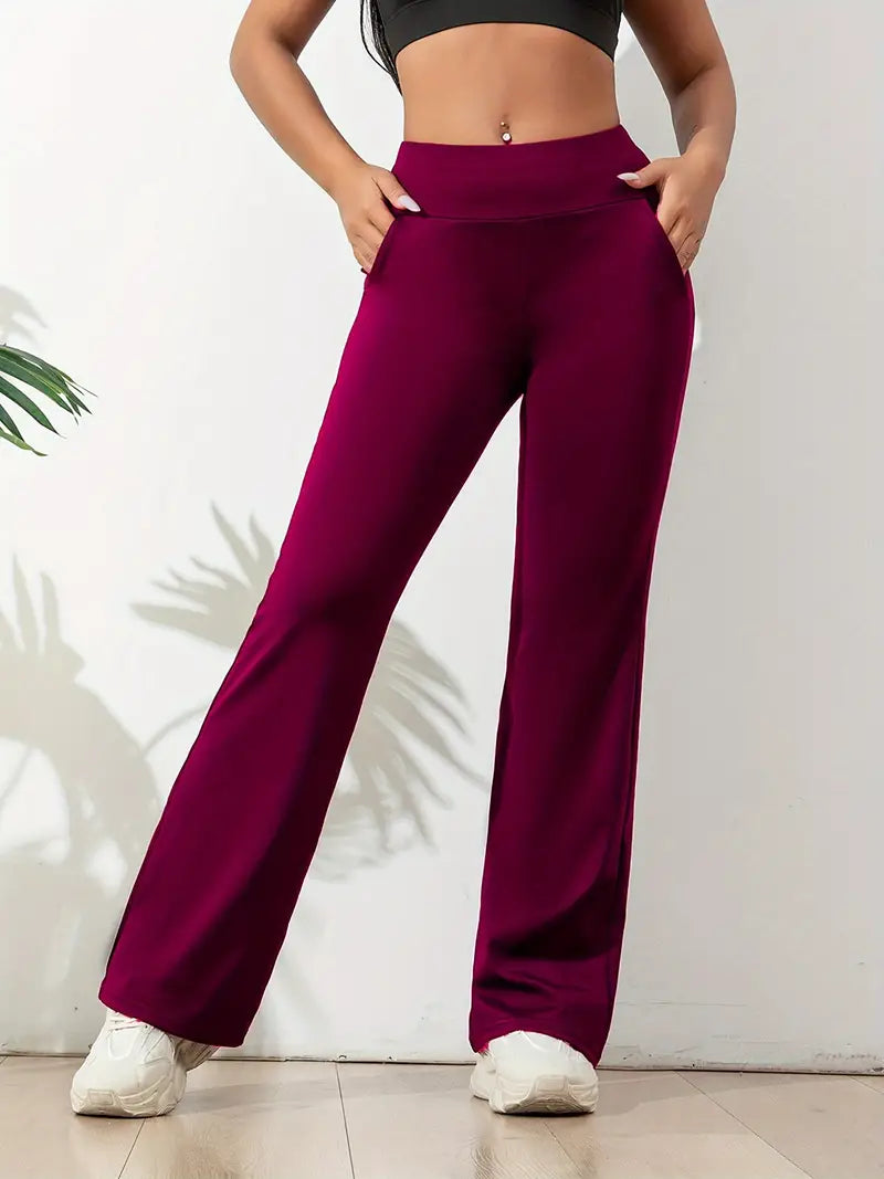 Legging bordeaux taille haute pour femme, coupe évasée avec poches latérales. Conçu pour le sport, le yoga ou les tenues décontractées, alliant confort, maintien et élégance moderne.