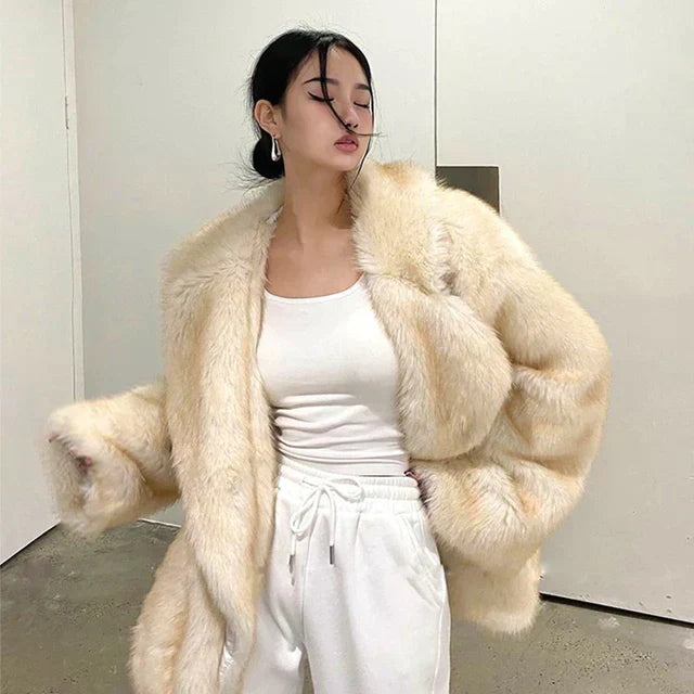 Manteau en fausse fourrure beige porté par une femme, offrant un style chic et décontracté tout en assurant chaleur et élégance pour la saison hivernale.