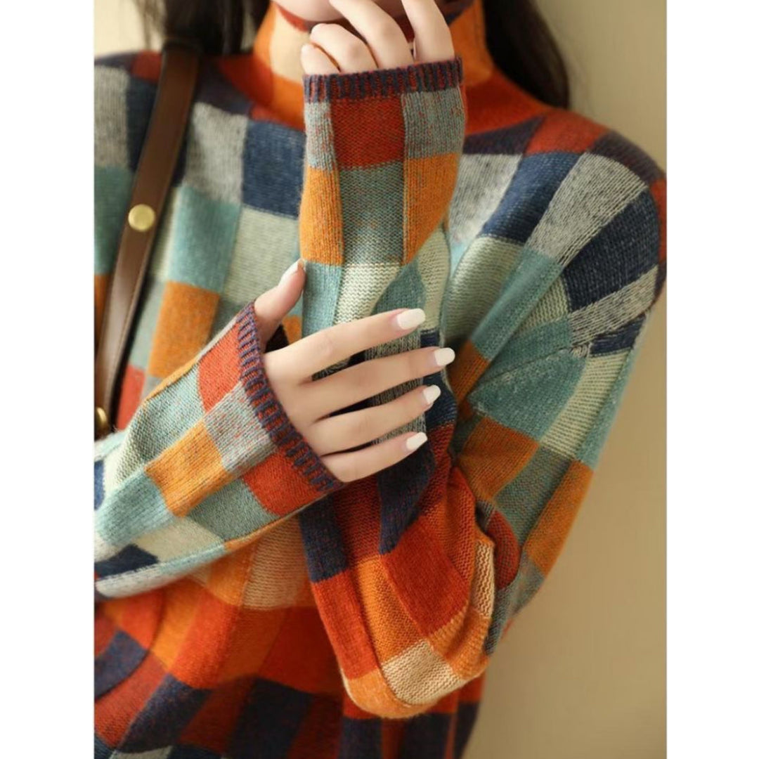 Pull Emphélie à carreaux tartan pour femme, motif tendance adapté aux tenues automnales colorées.