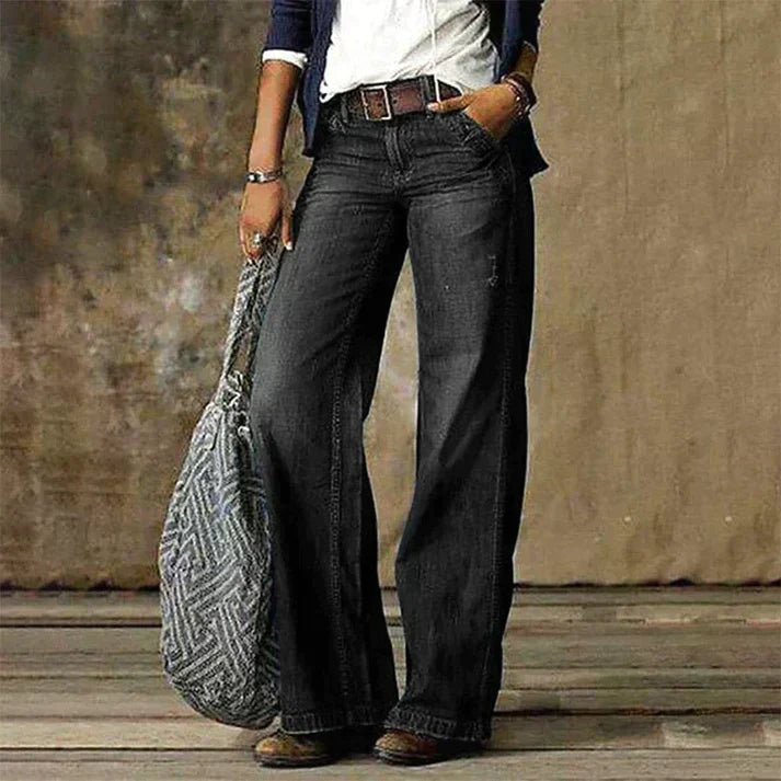 Anne, pantalon tailleur pour femme taille haute, coupe large et fluide en jean noir délavé, style élégant et décontracté.