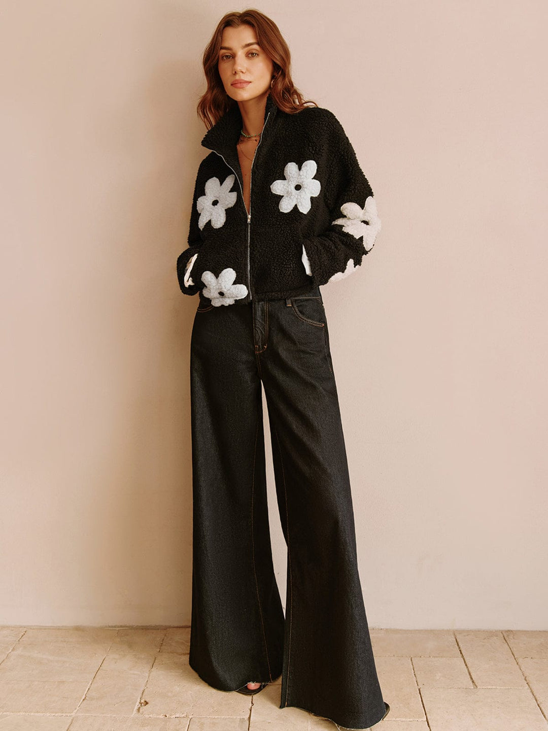 Ajoutez une touche de fraîcheur à votre garde-robe avec cette veste courte à fleurs blanches. Associez-la à un pantalon large pour un look à la fois décontracté et moderne. Une pièce parfaite pour un style chic et tendance, idéale pour les journées fraîches.