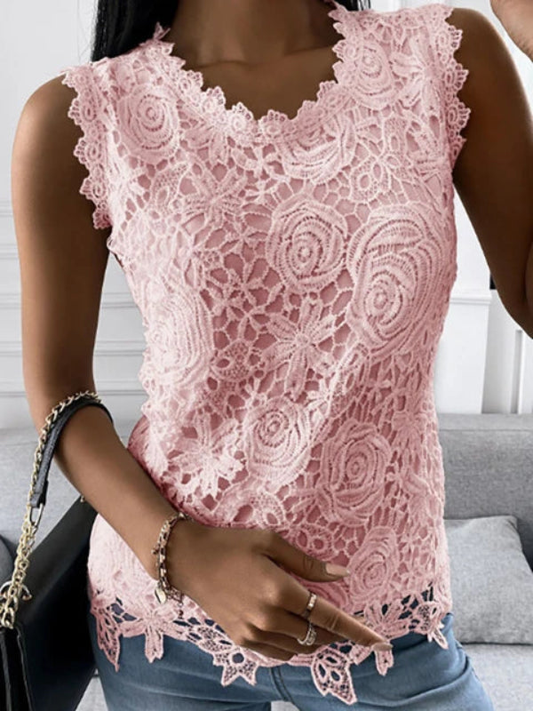 Top femme rose pâle en dentelle florale, sans manches avec encolure en V festonnée, porté avec un jean.