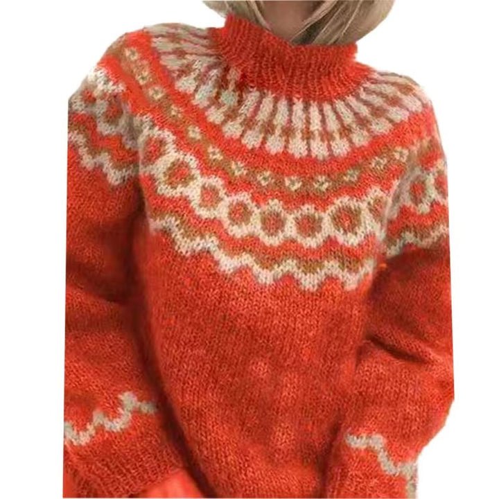 Femme portant un pull épais à col montant en maille douce de couleur orange vif. Le pull présente un motif nordique géométrique en beige et blanc sur le haut et les manches, offrant un style chaleureux, cosy et idéal pour l’hiver.