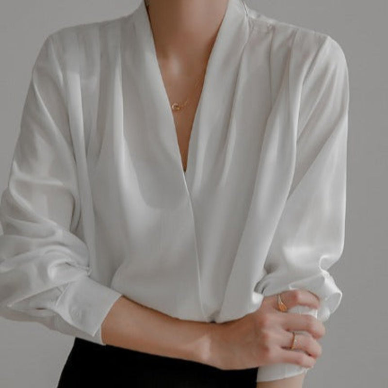 Blouse fluide blanche élégante, col en V croisé, manches longues avec poignets boutonnés, style raffiné parfait pour le bureau ou les occasions spéciales.