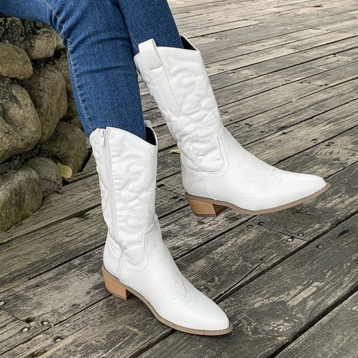 Bottes western métalliques pour femme Hélyne en blanc, avec des détails brodés raffinés, une finition brillante et un talon en bois, parfaites pour un look élégant et moderne.