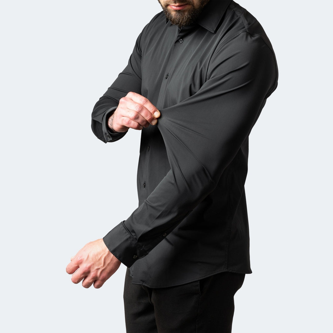Chemise stretch à manches longues pour homme, modèle Julien, de couleur noire, coupe ajustée, tissu extensible démontré au niveau de la manche pour un confort optimal et une grande liberté de mouvement, idéale pour un look moderne et élégant.