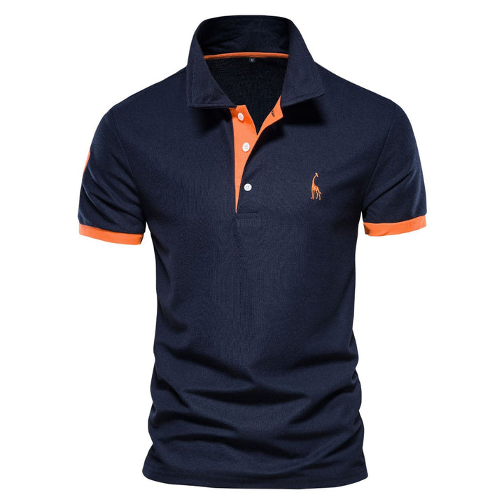 Polo pour homme à manches courtes de couleur bleu marine, avec col classique, patte de boutonnage contrastée orange et finitions contrastées aux manches, présenté sur fond blanc.