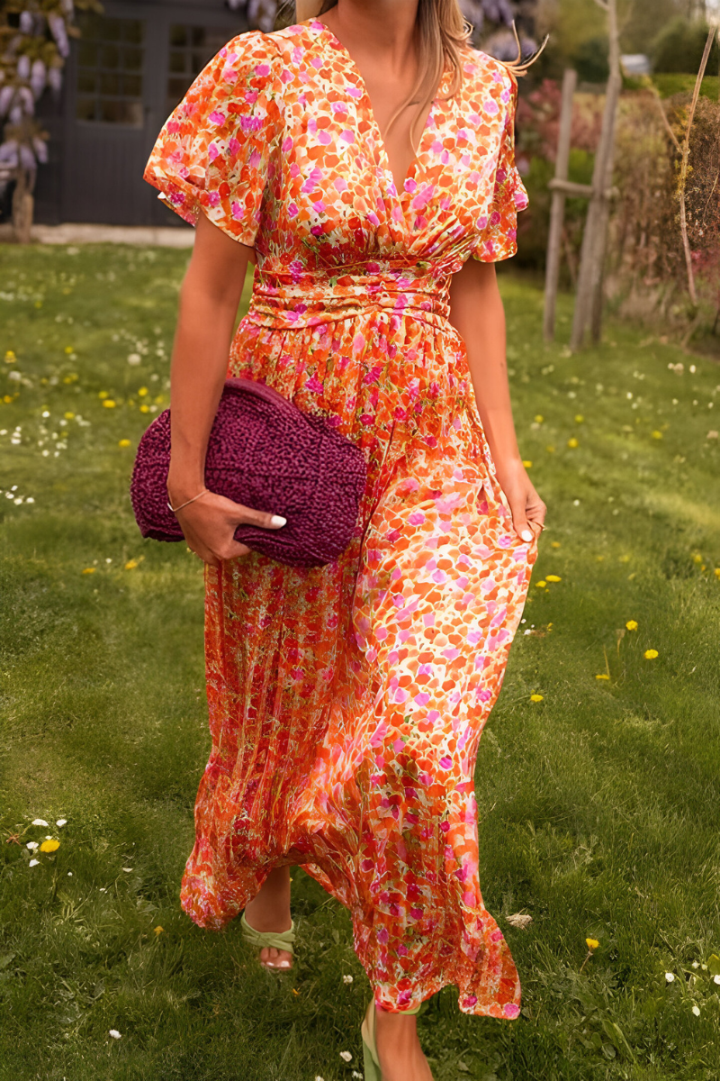 Robe longue à col en V pour femme, modèle tendance. Cette robe fluide et colorée, aux motifs floraux dans des teintes vibrantes de rose, orange et jaune, est parfaite pour les journées estivales. Portez-la avec des accessoires modernes comme un sac en crochet violet et des sandales élégantes. Un choix incontournable pour un look chic et décontracté.