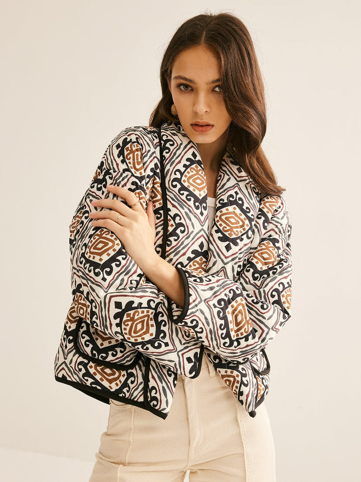 veste imprimée géométrique noir, brun et beige, coupe ample avec manches larges et ourlet droit, look moderne et tendance.