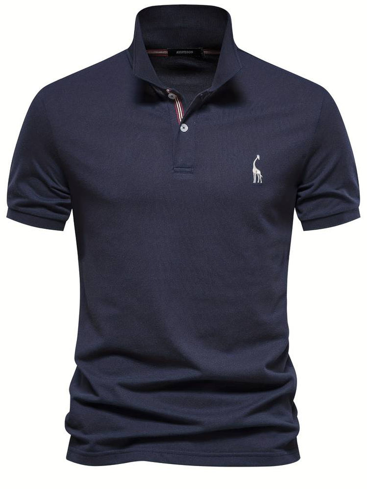 Polo moderne pour homme Sami, bleu marine à manches courtes, avec col structuré, patte de boutonnage et logo brodé discret sur la poitrine, pour un style élégant et contemporain.
