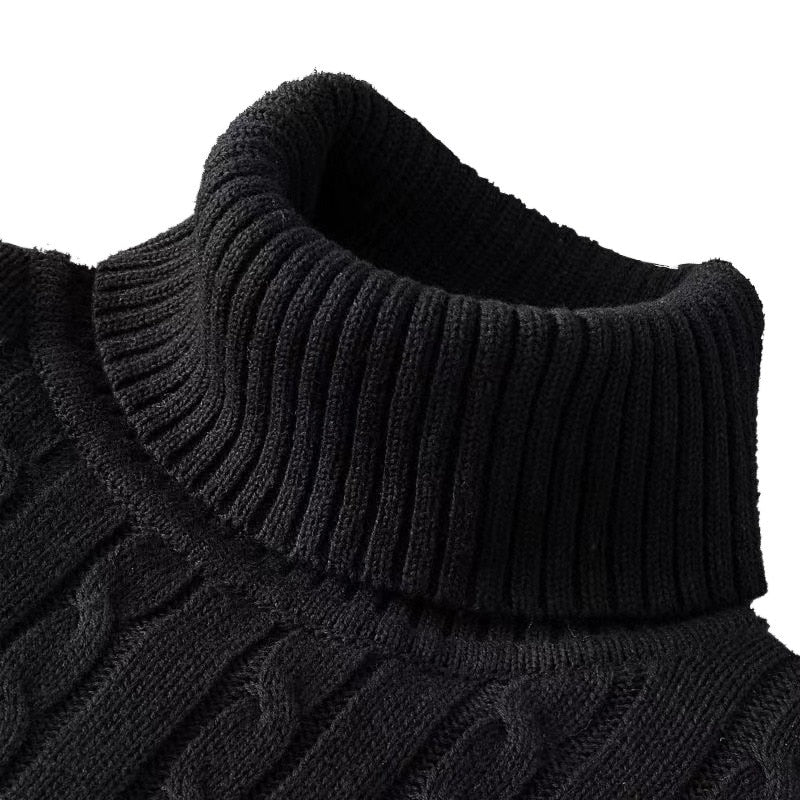 Pull en maille torsadée noir avec col roulé épais, offrant chaleur, confort et style pour l’hiver.