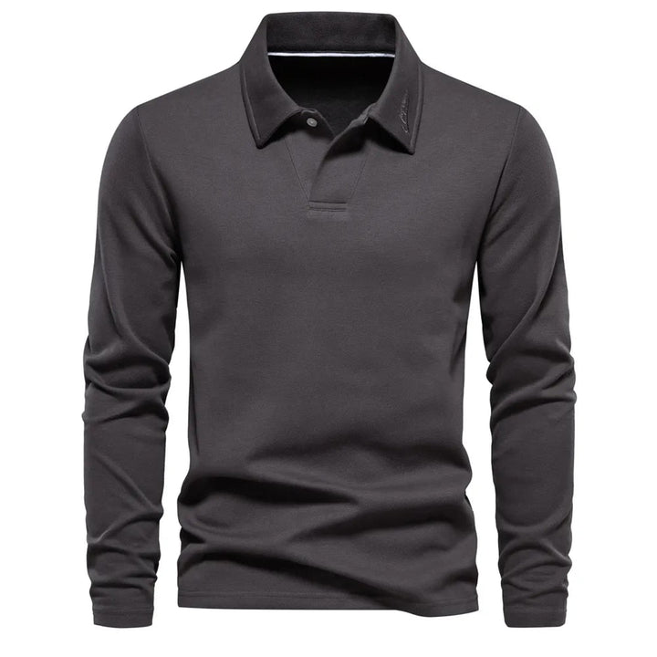 Polo homme gris foncé à manches longues, coupe ajustée et design moderne, avec col classique et finition épurée.