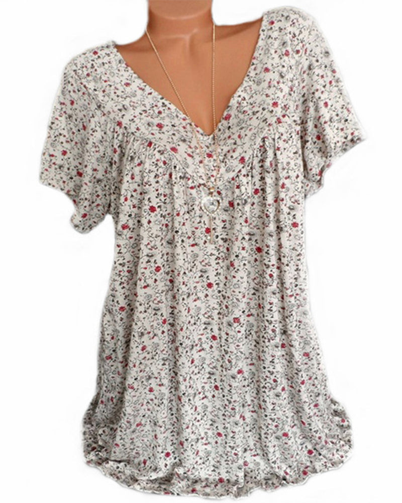 Blouse Verity pour femme à manches courtes, coupe ample et fluide avec col V, imprimé fleuri moderne beige clair avec petites fleurs rouges et motifs noirs, idéale pour un style décontracté et élégant.
